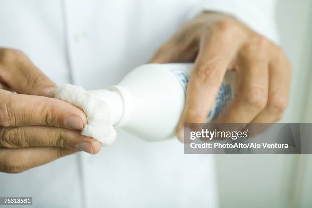 doctor putting antiseptic on cotton ball, close-up of hands - cotton ball stock-fotos und bilder