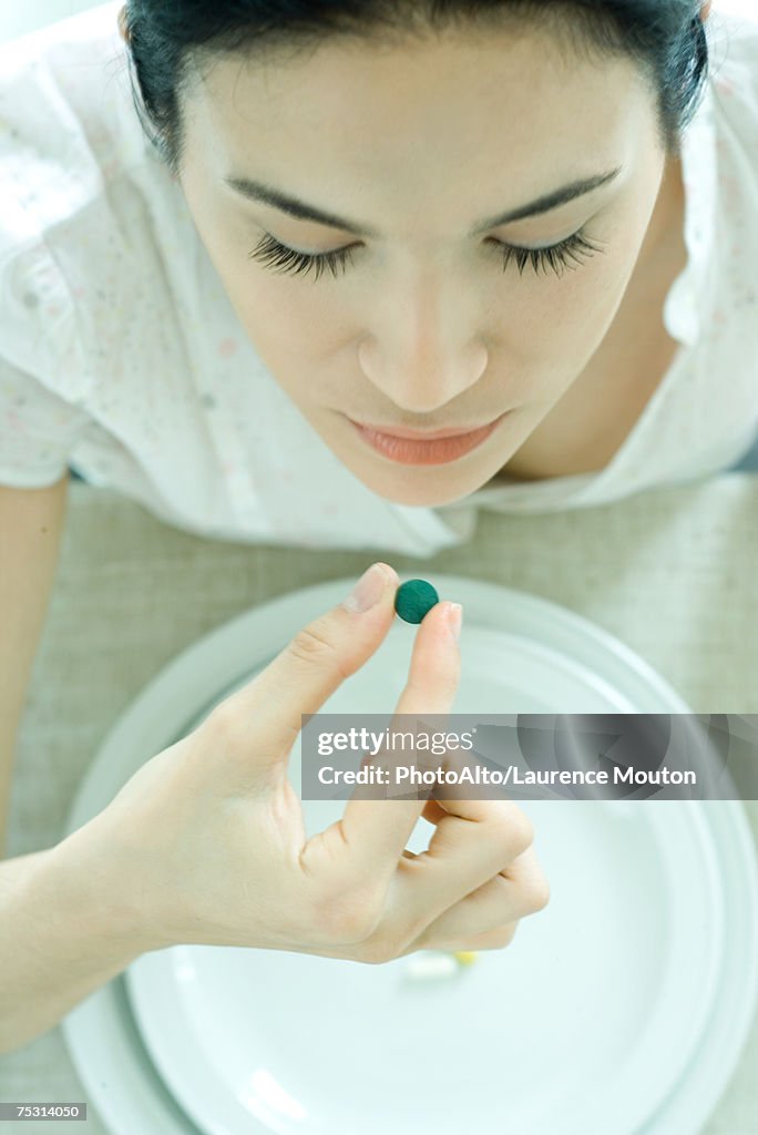 Woman taking vitamin