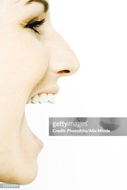 young woman's face with mouth wide open, profile - face and profile and mouth open stock-fotos und bilder