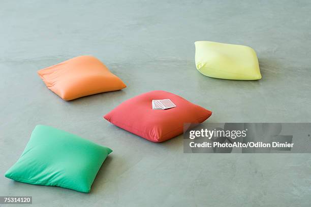 cushions on floor, deck of cards on one cushion - cushion imagens e fotografias de stock
