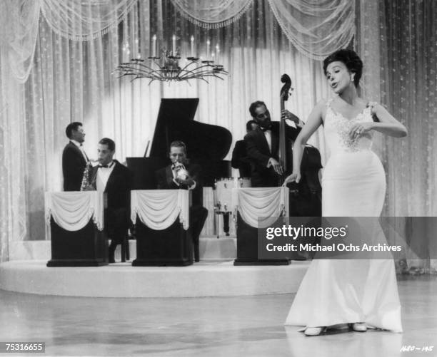 Circa 1950: Lena Horne performs on the set of a movie with Dexter Gordon on saxophone circa 1950 in Los Angeles, California.