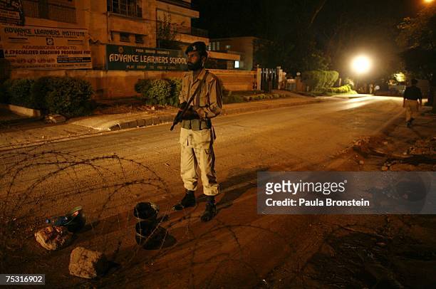 Pakistani military stand guard near the Red Mosque in Islamabad on July 10, 2007 after a bloody siege that killed the rebel leader, Abdul Rashid...