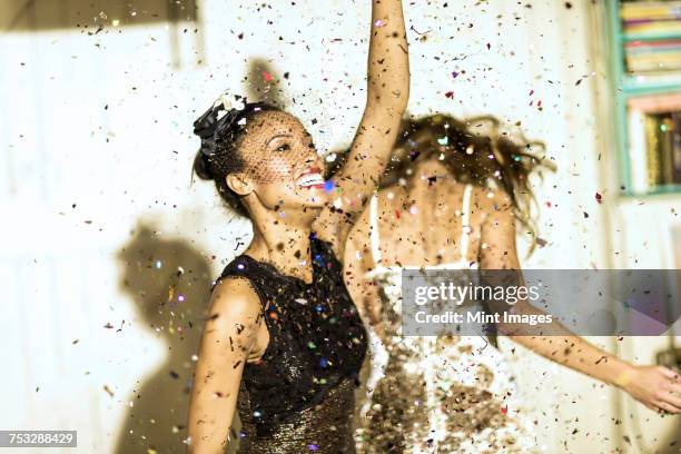 two young women dancing with confetti falling. - fall fashion event bildbanksfoton och bilder