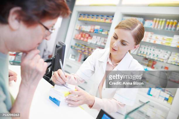 young pharmacist helping elderly customer. rzeszow, poland - anna of poland fotografías e imágenes de stock