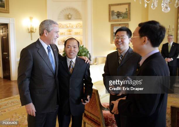 President George W. Bush meets with Chinese Human Rights activists Li Baiguang, Wang Yi, and Yu Jie in the Yellow Oval Room of the White House in...