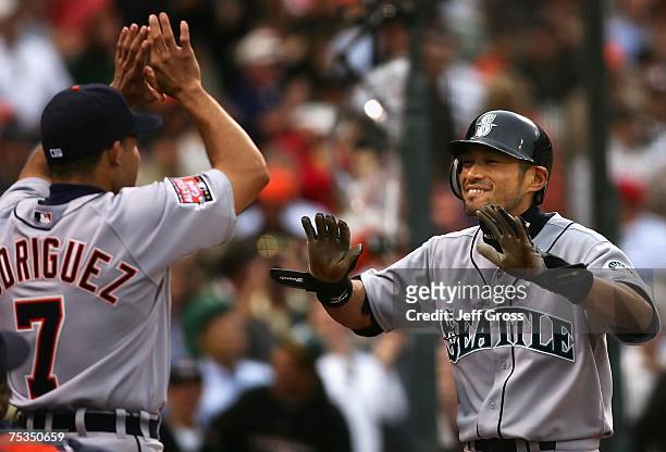 American League All-Star Ichiro Suzuki of the Seattle Mariners celebrates with teammate Ivan Rodriguez of the Detroit Tigers after Suzuki's inside...