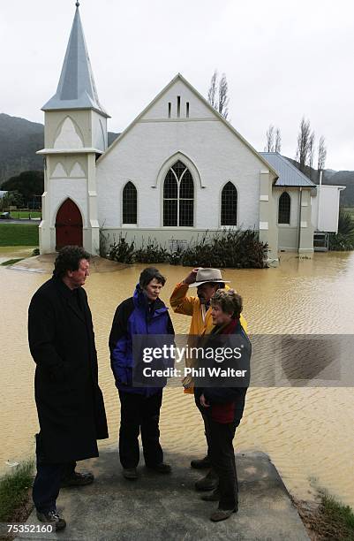 Civil Defence Minister Rick Barker, Prime Minister Helen Clark, Dover Samuels and far north Mayor Yvonne Sharpe visit the flooded town of Kaeo July...