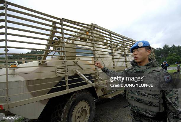 South Korean soldier who will join the UN peace keeping forces in Lebanon, guides an armored car during a drill at a military camp in Gwangju, 38...