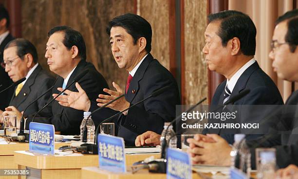 Japan's Prime Minister and ruling Liberal Democratic Party President Shinzo Abe answers questions while other party leaders listen during a debate...