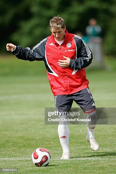 Bastian Schweinsteiger shoots the ball during the training session at the training camp of Bayern Munich on July 11, 2007 in Donaueschingen, Germany.