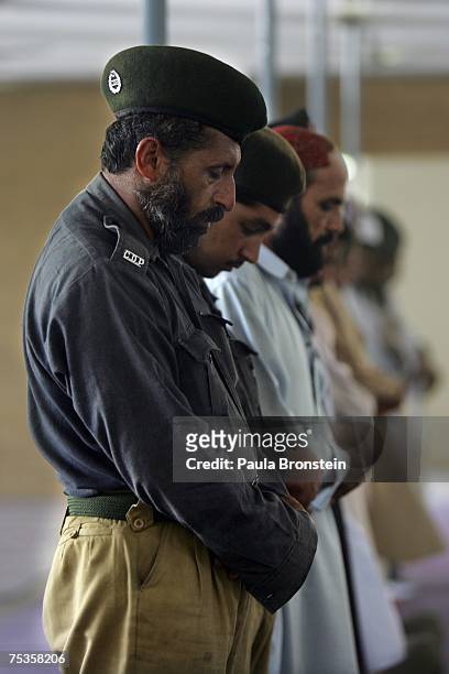 Pakistani military and police pray at a mosque near the Red Mosque on July 11, 2007 in Islamabad, Pakistan. The cleanup operation continues after the...