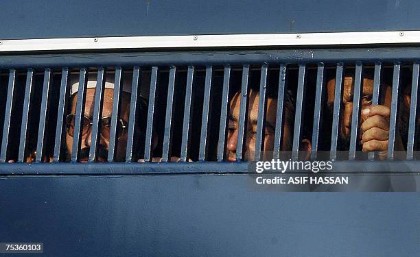 Detained Pakistani religious students of the Red Mosque look out from a prisoner van as they arrive from the Adiala jail, where they were locked...