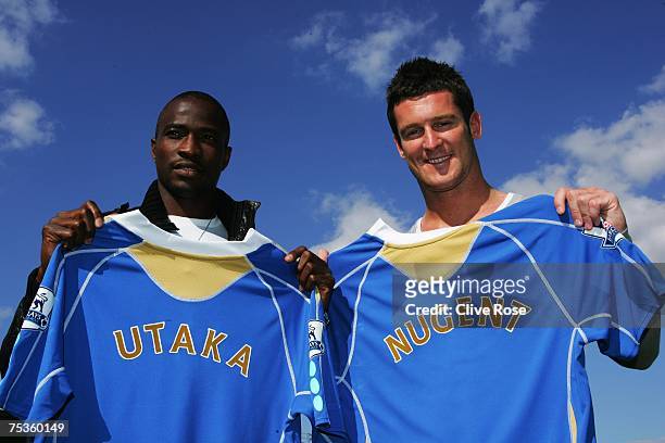 John Utaka and David Nugent pose with their respective Portsmouth team shirts after a press conference at Fratton Park on July 11, 2007 in...