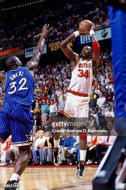 Hakeem Olajuwon of the Houston Rockets attempts a shot against Shaquille O'Neal of the Orlando Magic in Game Four of the 1995 NBA Finals at the...