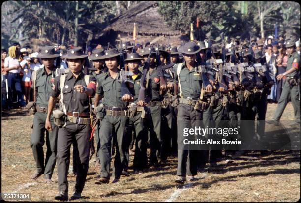 Rebel troops of the Mon People's Front parade at a jungle base camp close to the Three Pagodas Pass in Burma, 21st March 1984. The Mon People's...