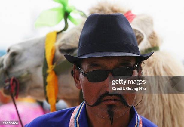 Mongolian man watches the world's tallest man Bao Xishun's traditional Mongolian wedding ceremony at the Genghis Khan Mausoleum Tourist District on...