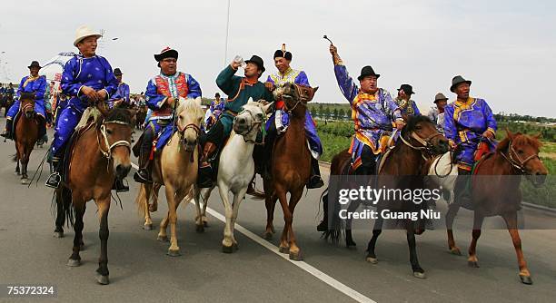 Mongolian herbsmen drink wine and sing as they ride horse to participate the world's tallest man Bao Xishun's traditional Mongolian wedding ceremony...