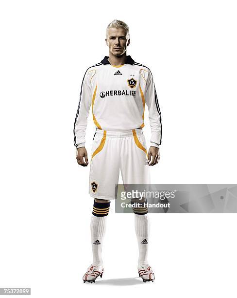 In this handout photo provided by Adidas, LA Galaxy star signing David Beckham poses wearing his new Galaxy strip on July 11, 2007 in Carson,...