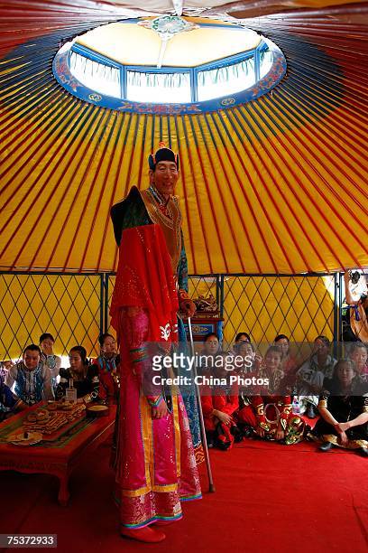 World's tallest man Bao Xishun and his bride Xia Shujuan attend their traditional Mongolian wedding ceremony at Genghis Khan's Mausoleum on July 12,...