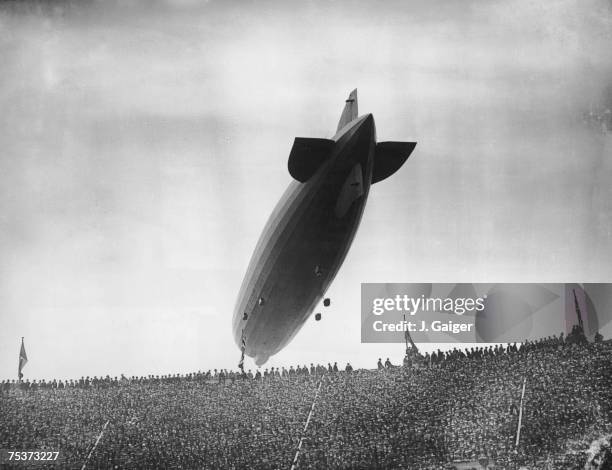 The Graf Zeppelin flying over Wembley Stadium during the FA Cup Final between Arsenal and Huddersfield Town, 26th April 1930. Arsenal won the match...