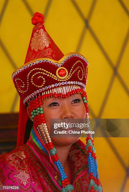 Bride Xia Shujuan awaits the world's tallest man Bao Xishun during their traditional Mongolian wedding ceremony at Genghis Khan's Mausoleum on July...