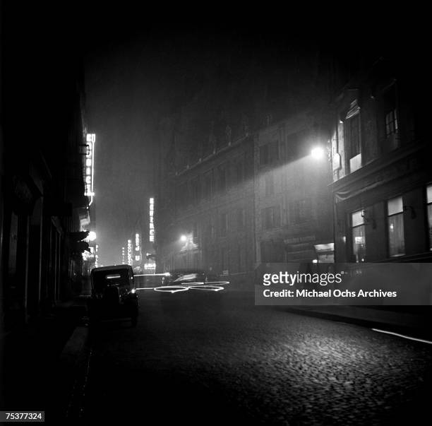 Nightclub exteriors on a foggy street at night on November 1 1948 in Paris, France.