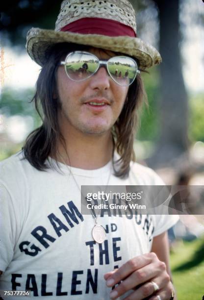 Singer/songwriter Gram Parsons wears a Gram Parsons and the Fallen Angels T-shirt at a party in the park in June 1973 in Los Angeles, California.