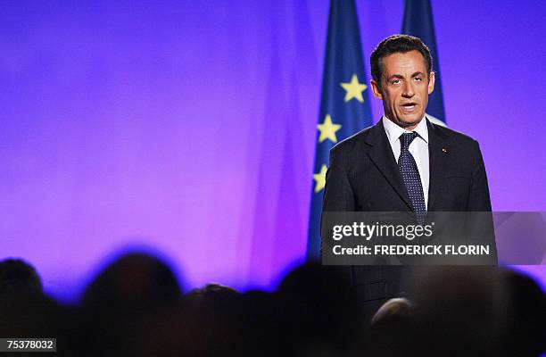 French President Nicolas Sarkozy sings the national anthem after a speech during a public meeting on democracy, 12 July 2007 in Epinal, eastern...