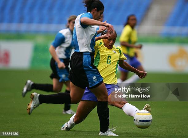 Rosana Augusto of Brazil stretches to stop the drive of Aida Camano of Uruguay during the women's football first round group A between Uruguay and...