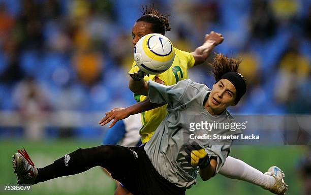 Luciana Gomez of Uruguay stops a shot by Rosana Augusto during the women's football first round group A game between Uruguay and Brazil at the Joao...