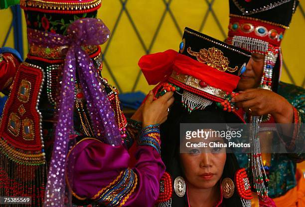The world's tallest man Bao Xishun's bride Xia Shujuan gets ready during their traditional Mongolian wedding ceremony at Genghis Khan's Mausoleum on...