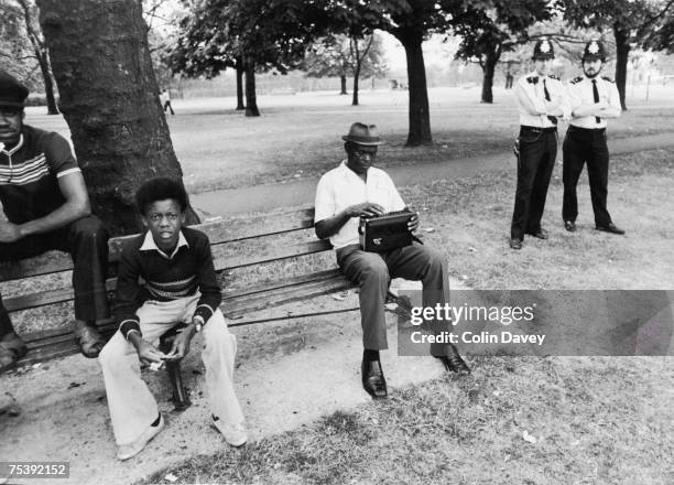 Man tuning his radio in West Ham Park, East London, while waiting to watch a cricket match, between the local police force and West Indians, 3rd...