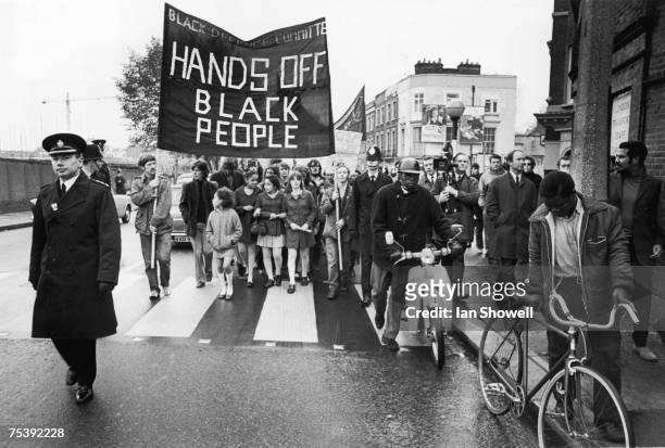 Demonstration passes Westbourne Park tube station during a protest against the repression of black citizens, organised by the Black Defence...