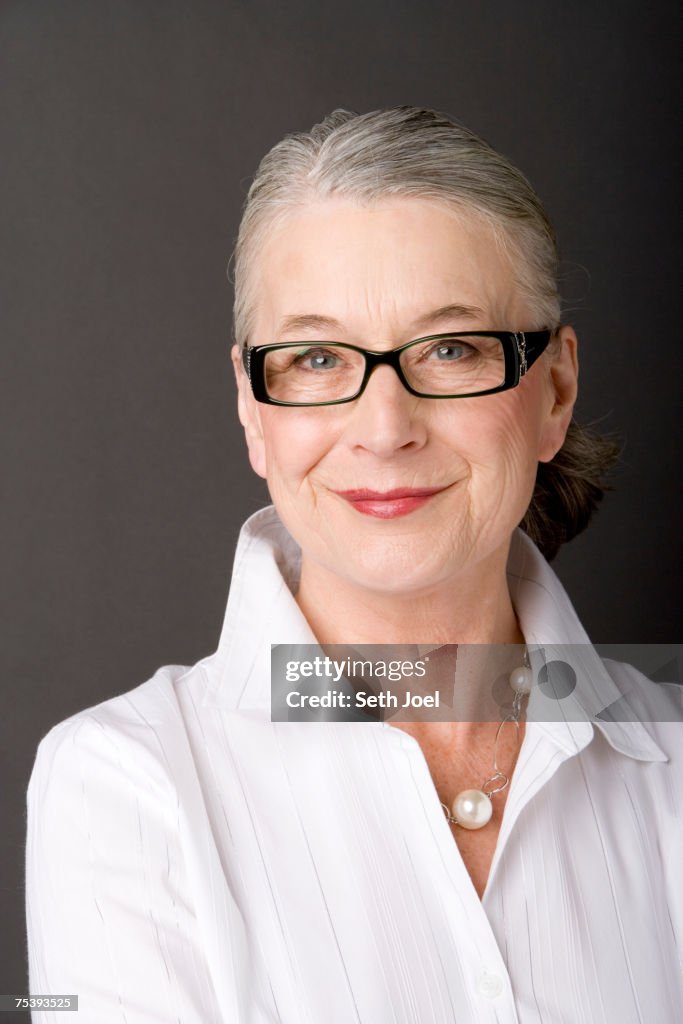 Smiling senior woman posing in studio, portrait