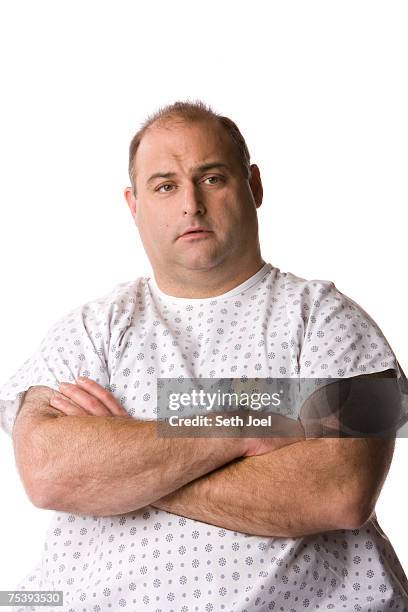 mature man wearing examination gown in studio, portrait - overweight 40 year old male concerned stock pictures, royalty-free photos & images