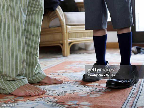 son wearing fathers shoes, close-up, low section - too big stock pictures, royalty-free photos & images
