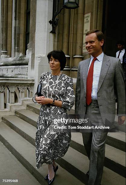 British novelist and statesman Jeffrey Archer and his wife Mary leave the law courts during his libel case against 'The Daily Star', 14th July 1987....