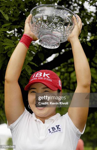 Jeong Jang raises her trophy after winning the Wegmans LPGA with a 13-under 275 at Locust Hill Country Club in Rochester, New York on Sunday, June...