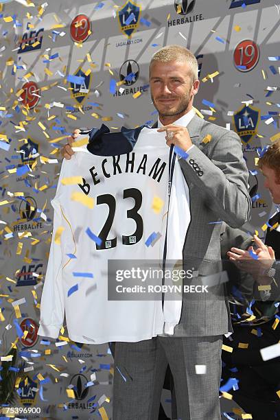 Carson, UNITED STATES: British soccer sensation David Beckham holds his new Los Angeles Galaxy football jersey during the presentation ceremony at...