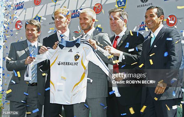 Carson, UNITED STATES: British soccer sensation David Beckham holds his new Los Angeles Galaxy football jersey during the presentation ceremony at...