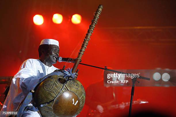 Guinean singer Mory Kante perfoms during a concert at Paris' Bastille square, 13 July 2007, as part of the July 14 celebrations. AFP PHOTO CLEMENS...