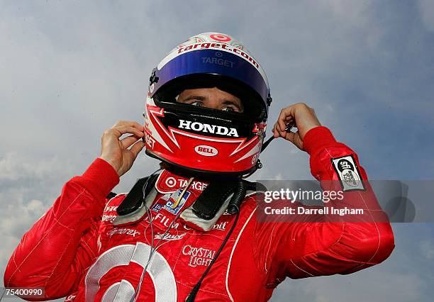 Dan Wheldon driver of the Target Chip Ganassi Racing Dallara Honda puts on his helmet during practice for the IRL IndyCar Series Firestone Indy 200...