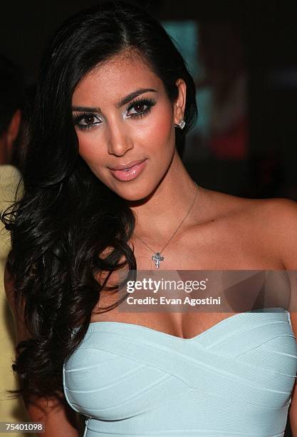 Socailite Kim Kardashian attends the Ashley Paige swimwear fashion show during "Mercedes Benz Fashion Week: Miami Swim" in the Cabana Grande tent at...