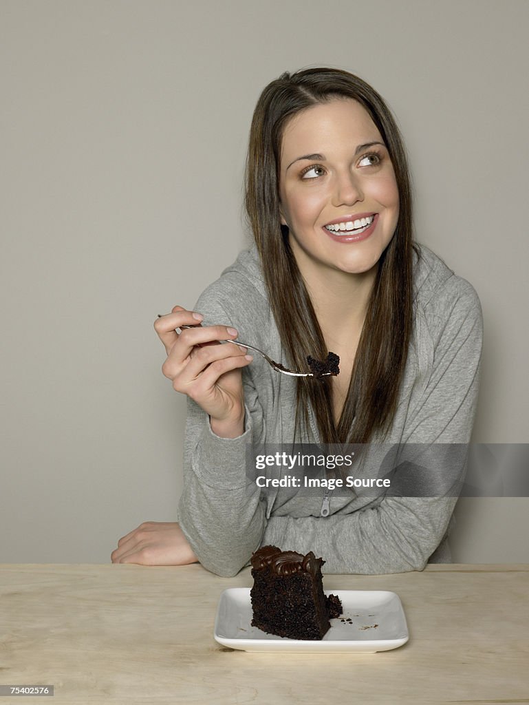 Young woman with chocolate cake