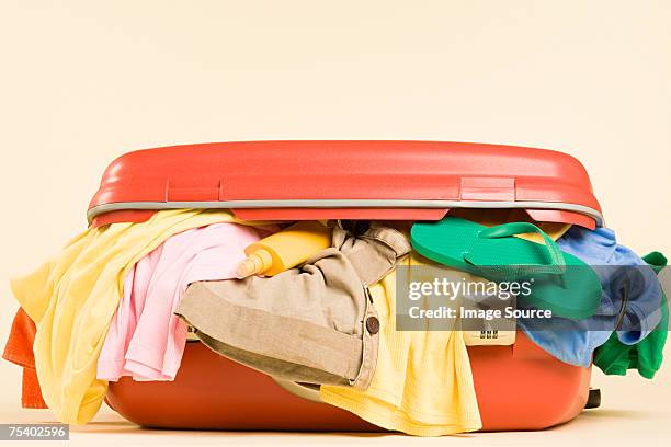 clothes in a suitcase - koffer niemand stock-fotos und bilder