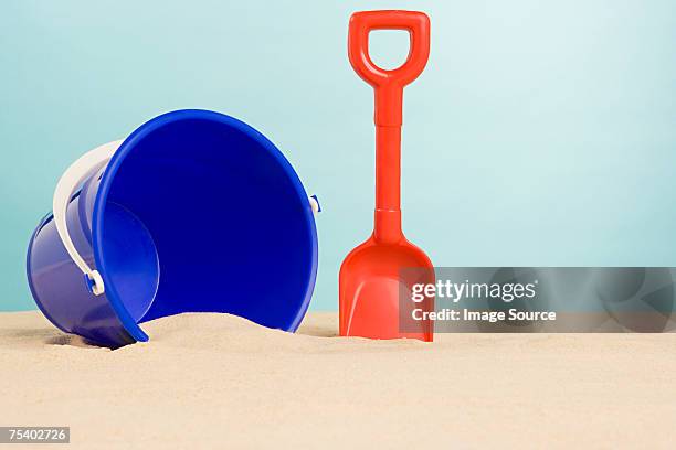 bucket and spade on beach - bucket and spade stock pictures, royalty-free photos & images