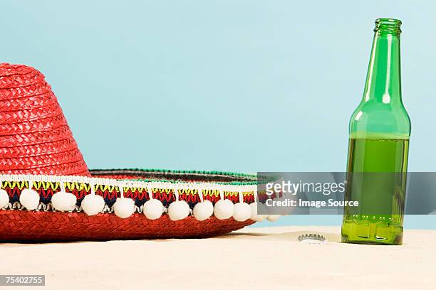 sombrero and beer bottle - sombrero stock pictures, royalty-free photos & images
