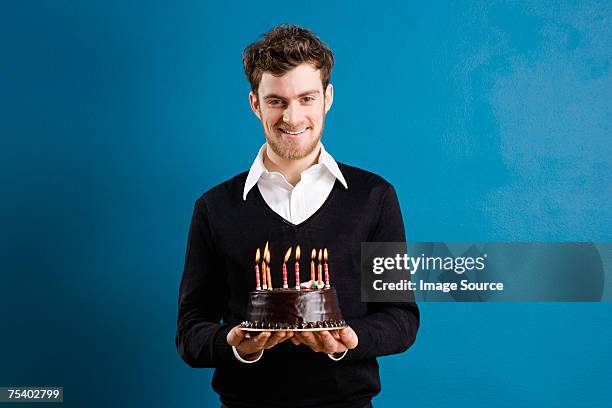 young man with a birthday cake - holding birthday cake stock pictures, royalty-free photos & images