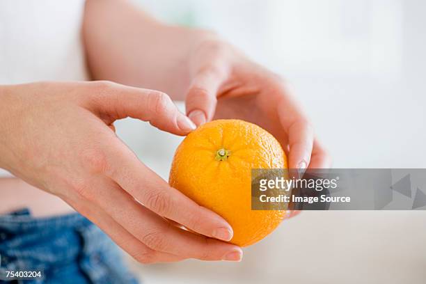 person holding an orange - peeling food stock pictures, royalty-free photos & images
