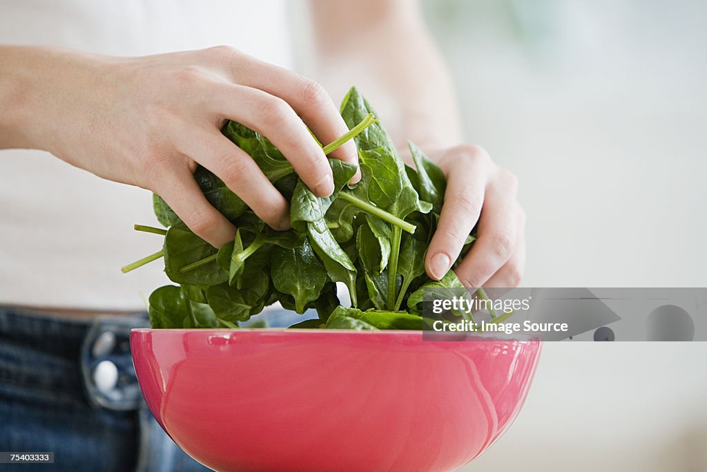 Person preparing spinach